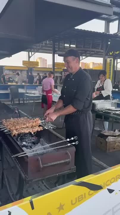 Повара «Вкусномира» тем временем жарят свиной и куриный шашлык для болельщиков