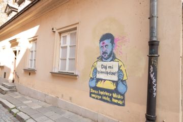 Поляки нарисовали несколько граффити с попрошайкой Зеленским в Варшаве, у которого табличка - Дай мне денег